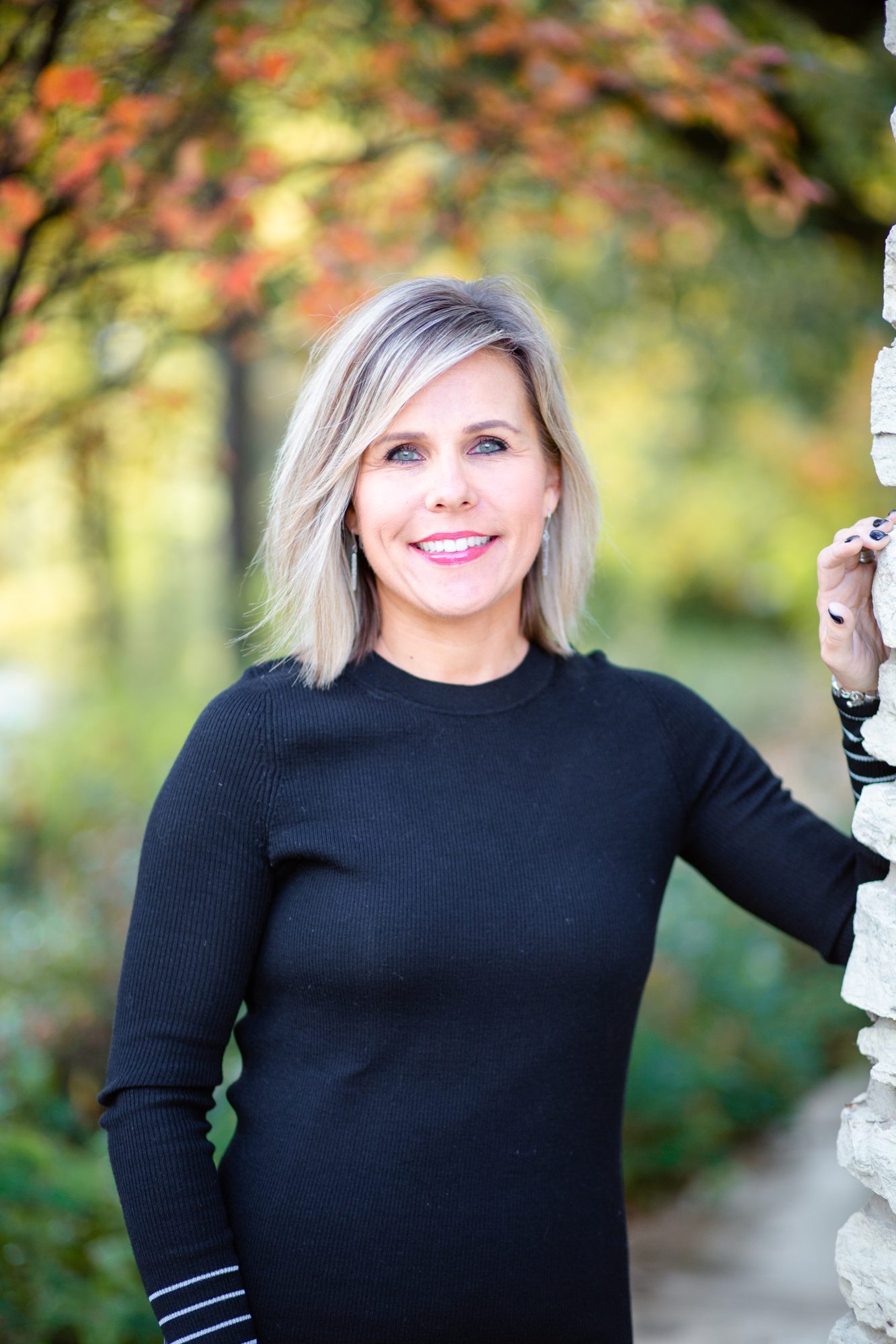 Heather Blanck dressed in black in a wooded area representing how she offers therapy for anxiety in Naperville.
